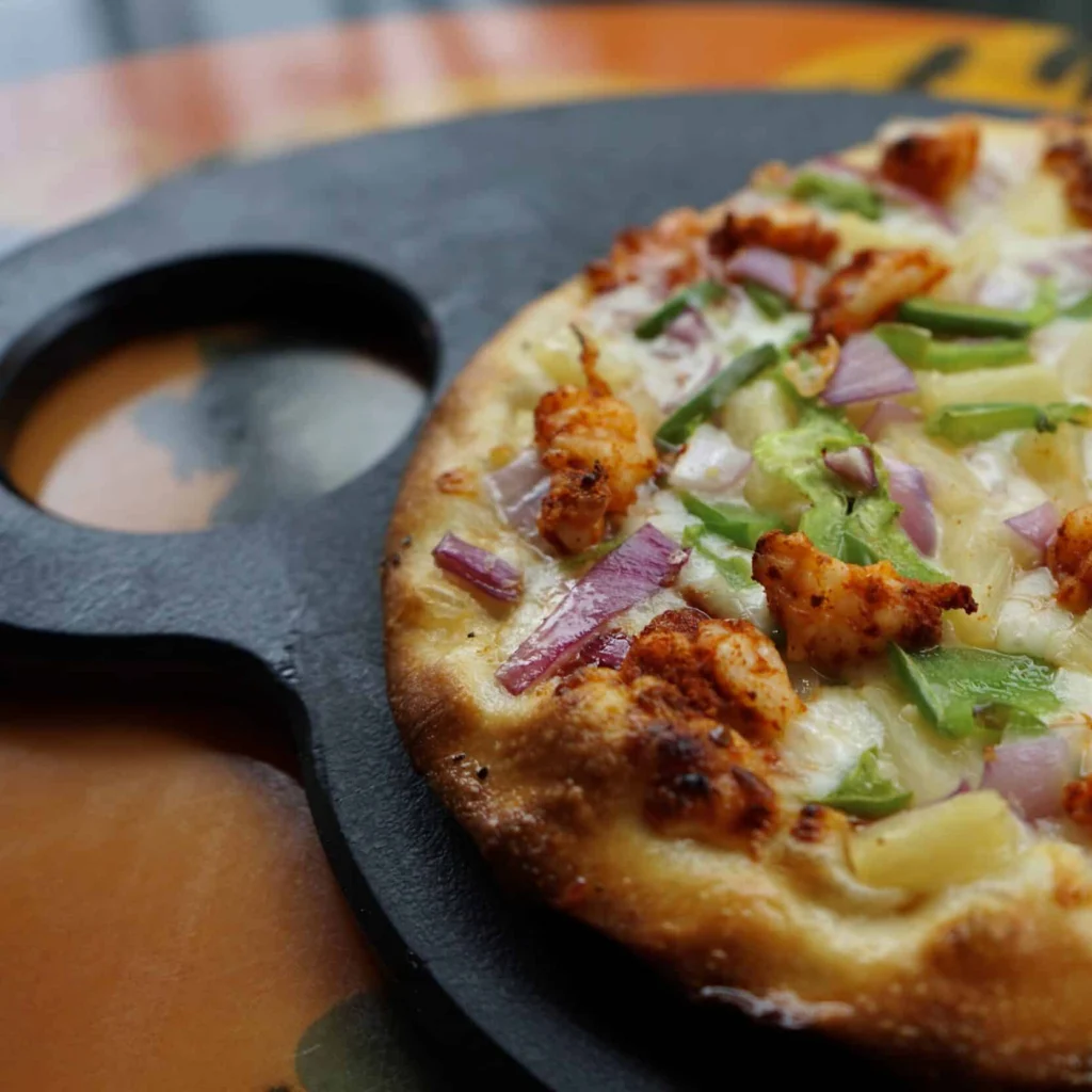 kids hand reaching for a slice of a personal pizza